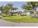 Desirable home exterior featuring mature trees, manicured lawn, and corner lot location at 5301 Linksman Pl, North Port, FL 34287
