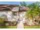 Charming single story home with a well manicured lawn, stone accents, and lovely palm trees at 5301 Linksman Pl, North Port, FL 34287