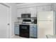 Kitchen area featuring updated cabinetry, appliances, and marble countertops at 5301 Linksman Pl, North Port, FL 34287