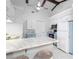 Bright kitchen with white cabinetry, marble countertops, and modern stainless-steel appliances at 5301 Linksman Pl, North Port, FL 34287