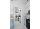 Passage to laundry room with washer, dryer, and storage cabinets at 5301 Linksman Pl, North Port, FL 34287