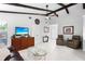 Spacious living room featuring wooden beams, tile flooring, and ample seating at 5301 Linksman Pl, North Port, FL 34287