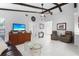 Spacious living room features high ceilings, wooden beams, and neutral decor at 5301 Linksman Pl, North Port, FL 34287