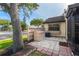 Outdoor patio and storage area with privacy fence, stone tiling, and large tree providing shade at 5301 Linksman Pl, North Port, FL 34287