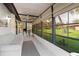 Enclosed patio with tile flooring, neutral colored furniture, and views of the lawn and backyard at 5301 Linksman Pl, North Port, FL 34287