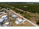 An aerial view showcasing the property's layout, including the pool, fenced yard, and surroundings at 5527 Fairway S Dr, Punta Gorda, FL 33982