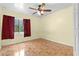 Bedroom featuring a ceiling fan, natural light, ceramic tile flooring, and neutral walls at 5527 Fairway S Dr, Punta Gorda, FL 33982