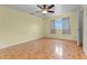 Bedroom featuring a ceiling fan, natural light, ceramic tile flooring, and neutral walls at 5527 Fairway S Dr, Punta Gorda, FL 33982
