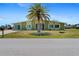 Charming home with a well-manicured lawn and a beautiful palm tree in the front yard at 5527 Fairway S Dr, Punta Gorda, FL 33982
