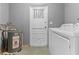 Laundry room featuring a utility sink, a water heater, and a washer and dryer at 5527 Fairway S Dr, Punta Gorda, FL 33982