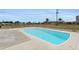 Backyard with a beautiful in-ground pool, surrounded by a concrete patio and chain link fence at 5527 Fairway S Dr, Punta Gorda, FL 33982