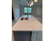 Kitchen island featuring a stainless steel sink, quartz countertops, and tiled base with electrical outlets on either side at 5970 Hornbuckle Blvd, North Port, FL 34291