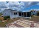 Home's backyard features a patio, a large screened-in lanai, and tropical landscaping at 6336 Drucker Cir, Port Charlotte, FL 33981