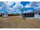 Backyard with a storage shed, palm tree, and screened-in lanai, offering outdoor living and storage solutions at 6336 Drucker Cir, Port Charlotte, FL 33981