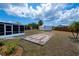 Spacious backyard featuring storage sheds and a tiled patio area, perfect for outdoor activities at 6336 Drucker Cir, Port Charlotte, FL 33981