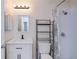 Updated bathroom featuring a modern vanity, stylish mirror, and shower with decorative curtain at 6336 Drucker Cir, Port Charlotte, FL 33981