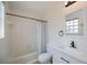 Clean bathroom featuring white fixtures, a shower-tub combo, and modern accents at 6336 Drucker Cir, Port Charlotte, FL 33981