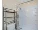 Bathroom featuring a shower with built-in shelves and a convenient shelving unit next to the toilet at 6336 Drucker Cir, Port Charlotte, FL 33981