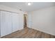 Bright bedroom with laminate flooring, a closet, and an open doorway to another room at 6336 Drucker Cir, Port Charlotte, FL 33981