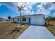 Charming home with a well-maintained lawn, a driveway, and an attached garage at 6336 Drucker Cir, Port Charlotte, FL 33981