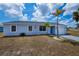 Inviting one-story home featuring a light blue exterior, bright blue door, and an attached one car garage at 6336 Drucker Cir, Port Charlotte, FL 33981