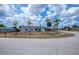Charming single-story home on corner lot with manicured lawn and mature palm trees at 6336 Drucker Cir, Port Charlotte, FL 33981