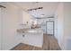 Bright kitchen features white cabinets, granite countertops, stainless steel appliances and wood floors at 6336 Drucker Cir, Port Charlotte, FL 33981