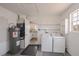 Clean laundry room with a washer and dryer, plus additional storage space and access to the kitchen at 6336 Drucker Cir, Port Charlotte, FL 33981
