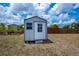 Outdoor storage shed with a window and door offering practical storage solutions for the home at 6336 Drucker Cir, Port Charlotte, FL 33981