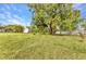 An expansive backyard with mature trees, a detached garage, and a well-maintained lawn at 6371 Mckinley Ter, Englewood, FL 34224