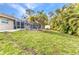 A generous backyard featuring a screened pool, a detached shed, and lush tropical landscaping at 6371 Mckinley Ter, Englewood, FL 34224