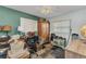 Bedroom with multiple windows, ceiling fan, and patterned carpet at 6371 Mckinley Ter, Englewood, FL 34224