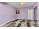 Empty bedroom features purple walls and mixed pattern flooring at 6371 Mckinley Ter, Englewood, FL 34224