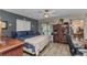 Cozy bedroom with a ceiling fan, wood flooring, and views of the outdoor patio and dining area at 6371 Mckinley Ter, Englewood, FL 34224