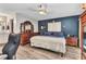 Bedroom features ceiling fan, wood floors, large bed, and dresser with vanity at 6371 Mckinley Ter, Englewood, FL 34224