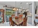 Open dining area with pool view, stylish table and chairs adjacent to a modern kitchen at 6371 Mckinley Ter, Englewood, FL 34224