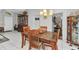 Charming dining area with tile floors, a modern light fixture, and convenient access to other rooms at 6371 Mckinley Ter, Englewood, FL 34224