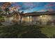 Charming one-story home featuring a well-maintained lawn and beautiful sky at sunset at 6371 Mckinley Ter, Englewood, FL 34224