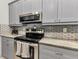 Well-equipped kitchen with stainless steel appliances, stylish countertops, and updated features at 6371 Mckinley Ter, Englewood, FL 34224