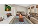 Spacious living room with tile floors, comfortable seating, and natural light from the windows at 6371 Mckinley Ter, Englewood, FL 34224