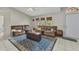 Bright living room with vaulted ceilings, tile flooring, and comfortable couches for relaxing at 6371 Mckinley Ter, Englewood, FL 34224