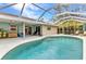 Relaxing screened-in pool featuring crystal clear water and a spacious deck area at 6371 Mckinley Ter, Englewood, FL 34224