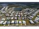 Aerial view of home with lush green landscape in a neighborhood community near a lake at 643 Blackburn Blvd, North Port, FL 34287