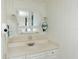 Bright bathroom with framed mirror, decorative lights, and white cabinets at 643 Blackburn Blvd, North Port, FL 34287