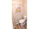 Charming bathroom features a painted mural, white fixtures, and wood-look floor at 643 Blackburn Blvd, North Port, FL 34287