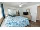 Bright bedroom features a ceiling fan, wood-look flooring and a mirrored closet at 643 Blackburn Blvd, North Port, FL 34287