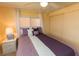 Cozy bedroom with ceiling fan, side table and closet at 643 Blackburn Blvd, North Port, FL 34287