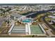 Aerial view of community, featuring a marina, swimming pool, clubhouse, and shuffleboard courts at 643 Blackburn Blvd, North Port, FL 34287