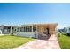 Inviting single-story home with a covered carport and screened porch at 643 Blackburn Blvd, North Port, FL 34287