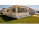Charming home exterior showcasing a sunroom with large windows and well-maintained lawn at 643 Blackburn Blvd, North Port, FL 34287